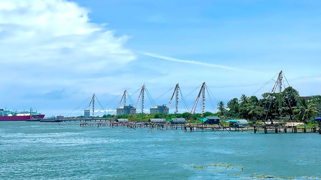 Traditional Chinese fishing nets line the waterfront in Cochin, India on a bright summer day. — lounges at Cochin Airport