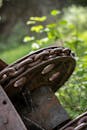 A rusty old wheel with chains on it