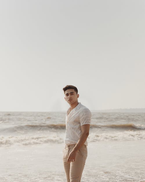Free Man Standing on Seashore Stock Photo