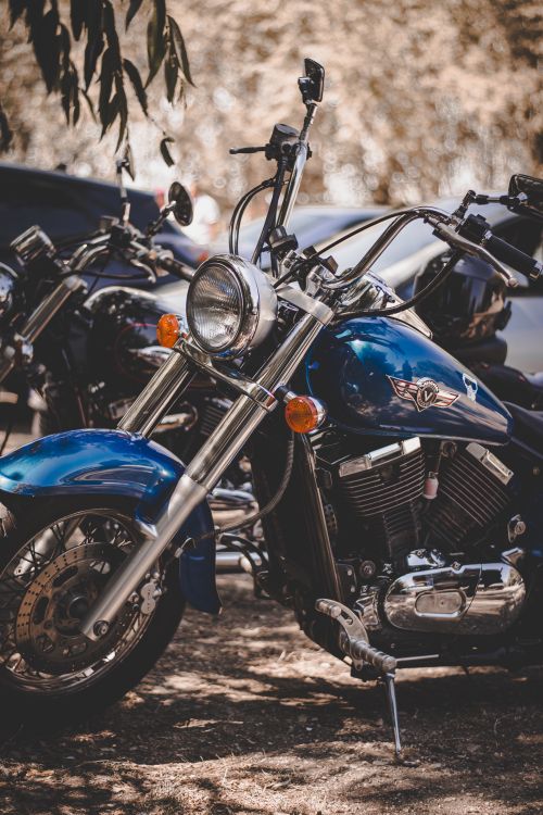 Free Close-up of a classic blue motorcycle parked outdoors, showcasing its chrome details. Stock Photo