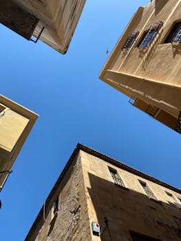 A view of historical buildings in Tarragona, Spain, under a clear blue sky.