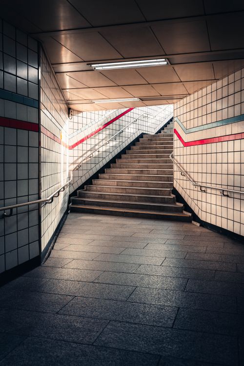 Free Stylish modern subway station with geometric tile patterns and stairway leading to city streets. Stock Photo