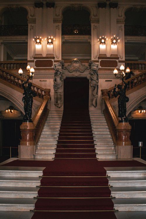 Free A luxurious indoor staircase with ornamental details in a grand historic structure. Stock Photo
