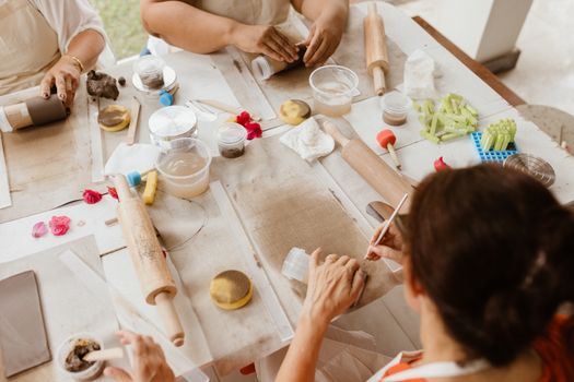 Hands-on pottery workshop with various tools and materials on a table