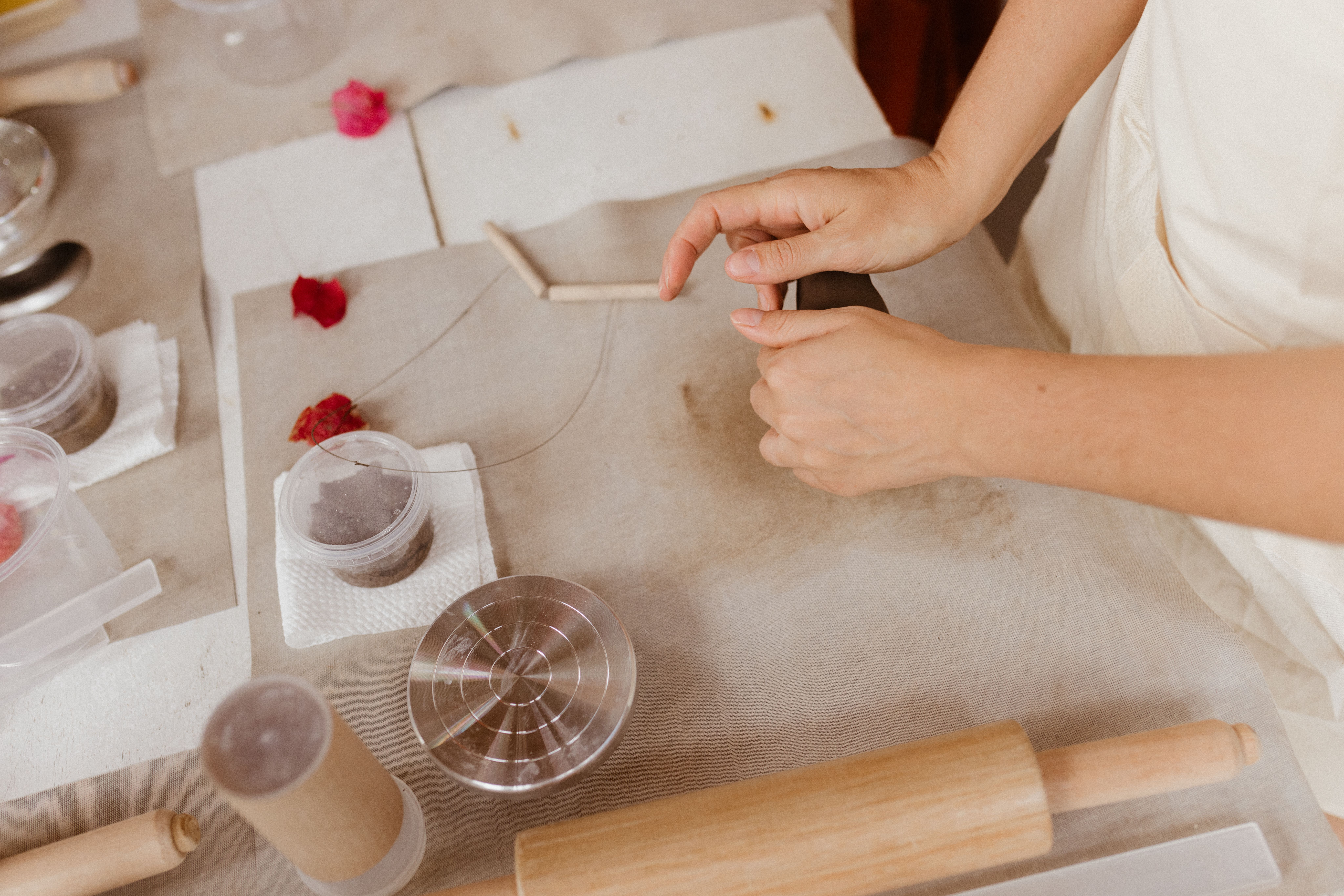 A woman is making a flower with a flower pot · Free Stock Photo