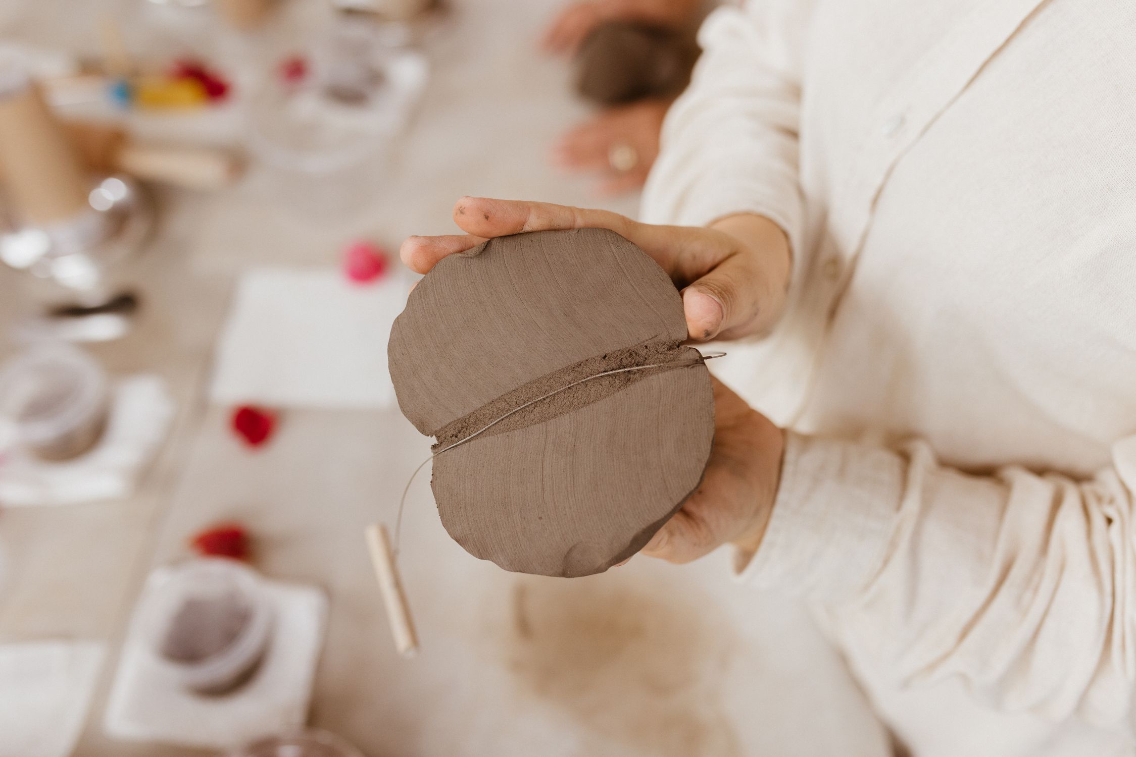 Person Using Clay A person holding a piece of clay in their hands · Free Stock Photo