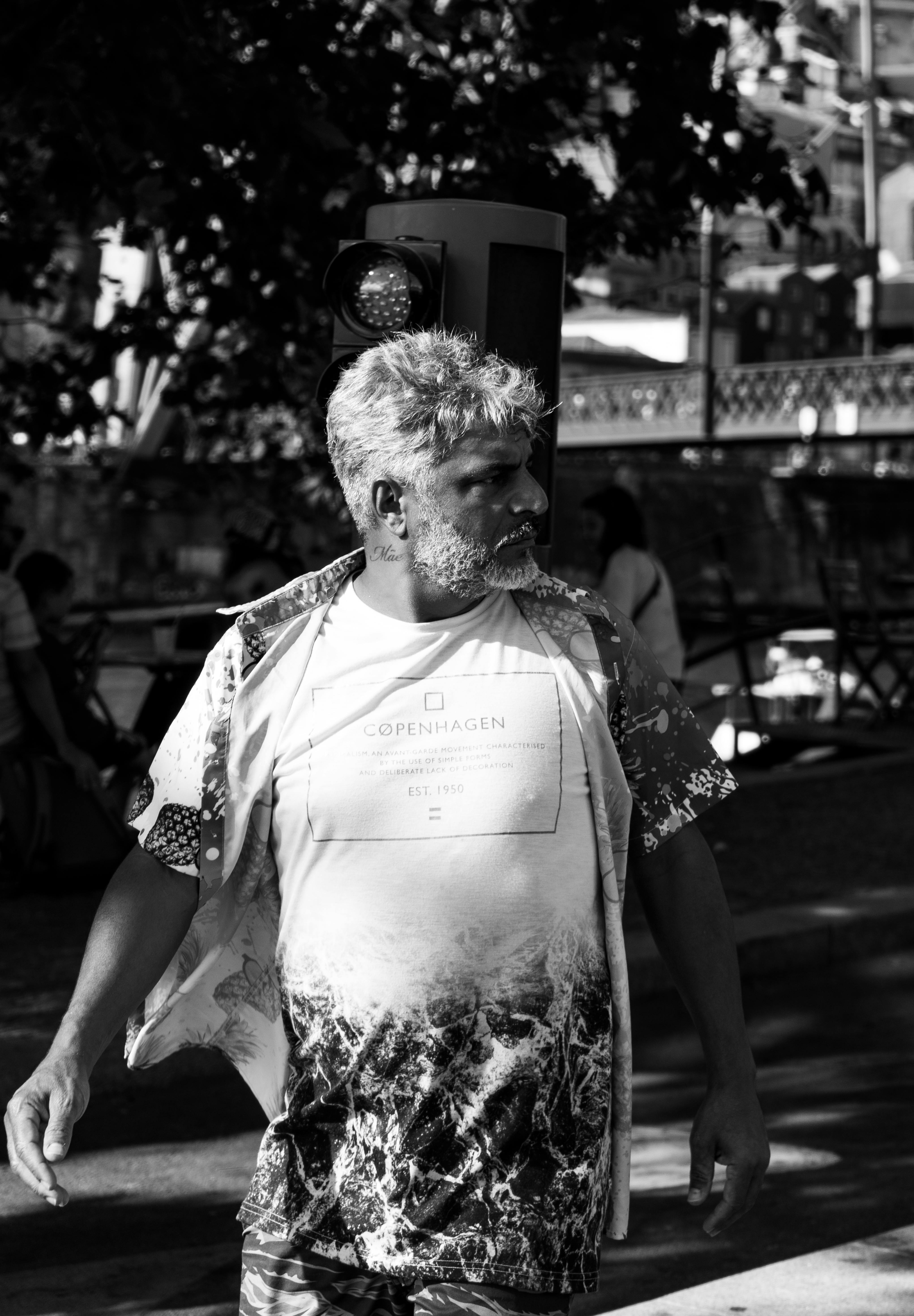 a man walking down the street with a cane