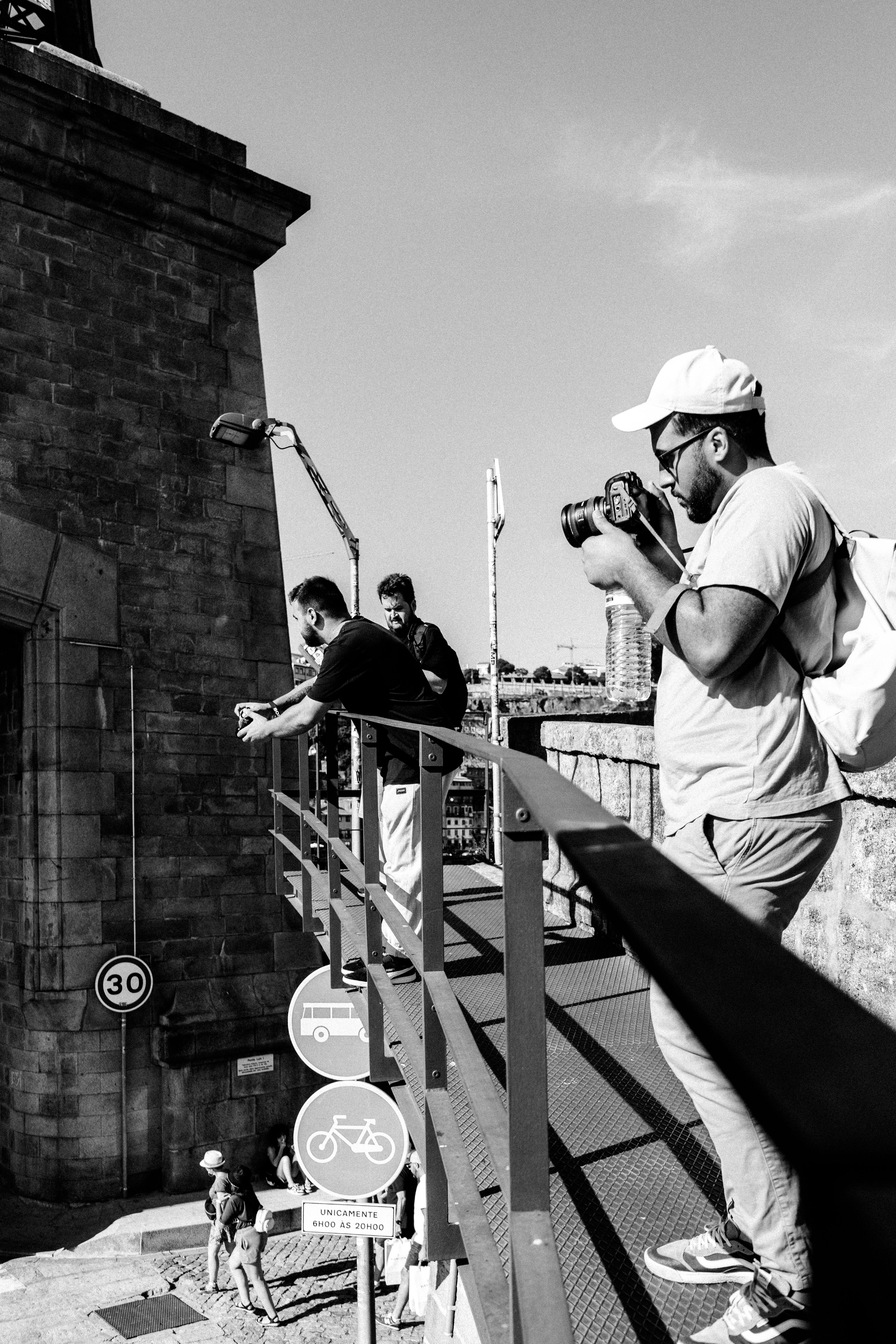 Black and white photo of street photographers capturing Porto's urban architecture.
