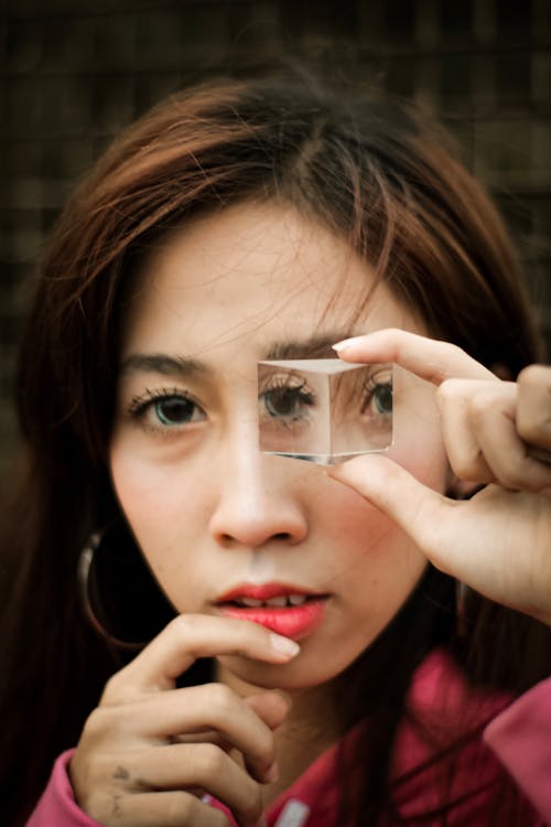 Free Woman Looking Through Clear Cube Stock Photo