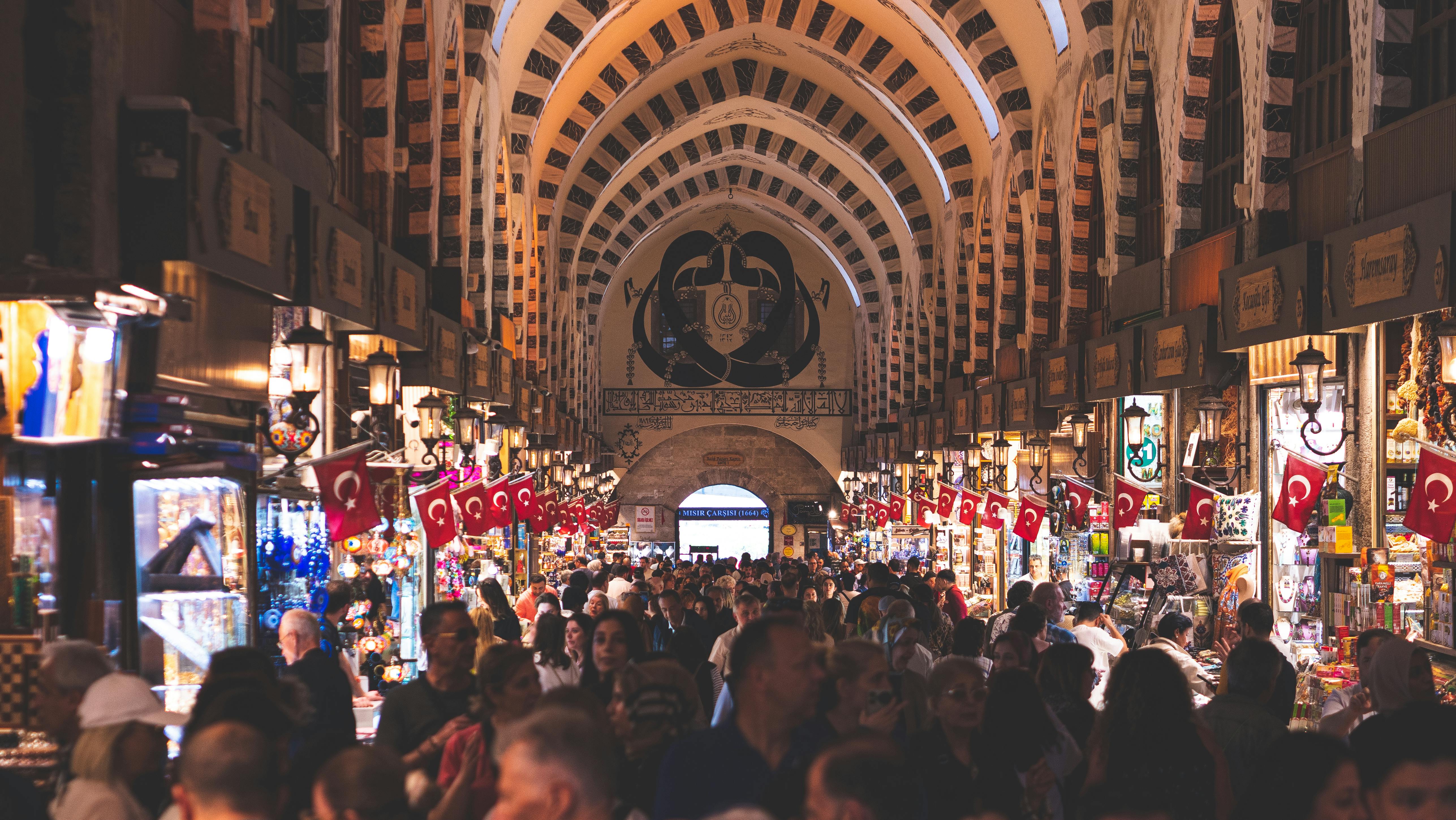 a crowded market with people walking around