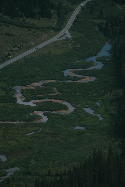 Aerial view of winding streams and lush green landscape near Twin Lakes, Colorado.