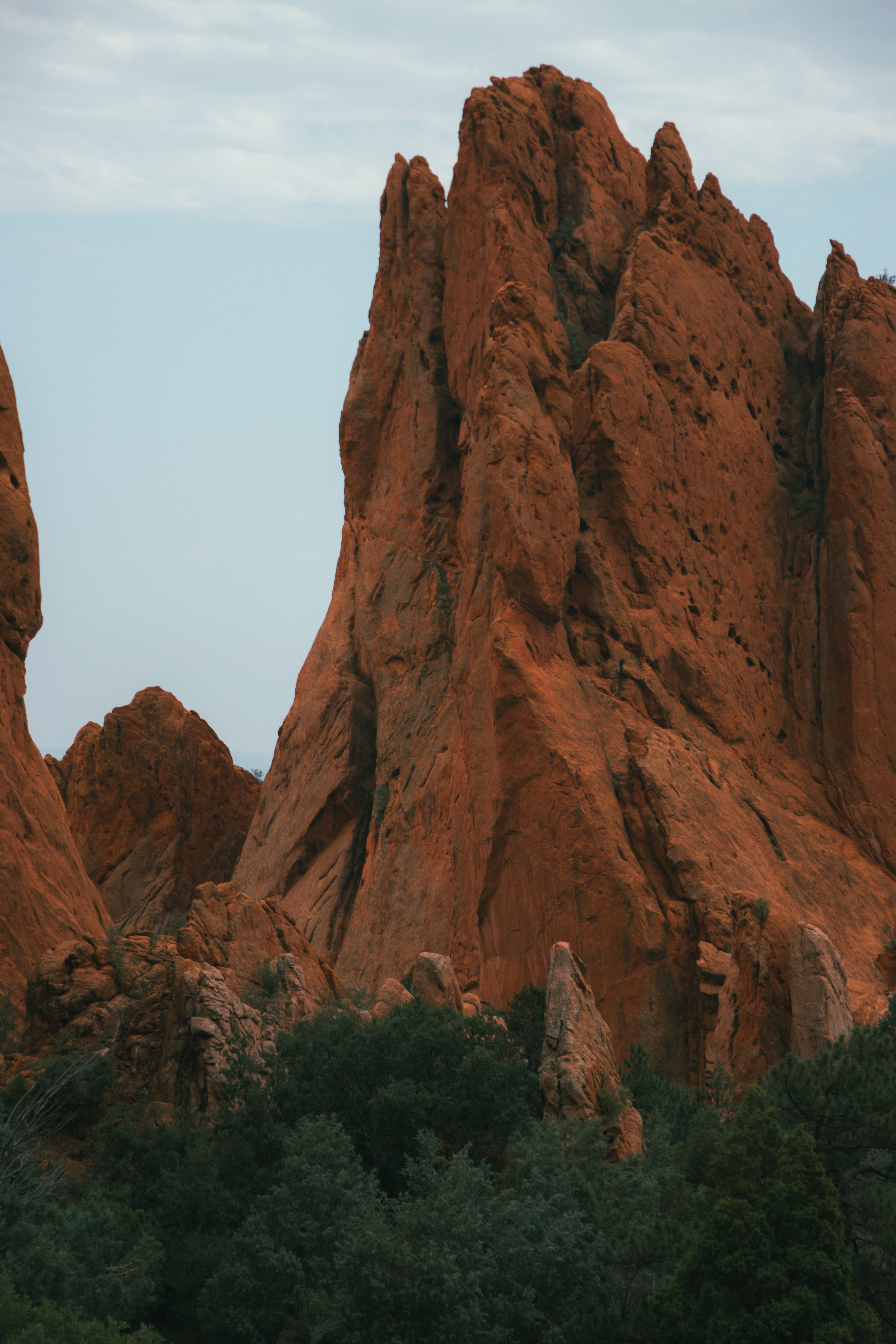 A large rock formation in the middle of a forest · Free Stock Photo