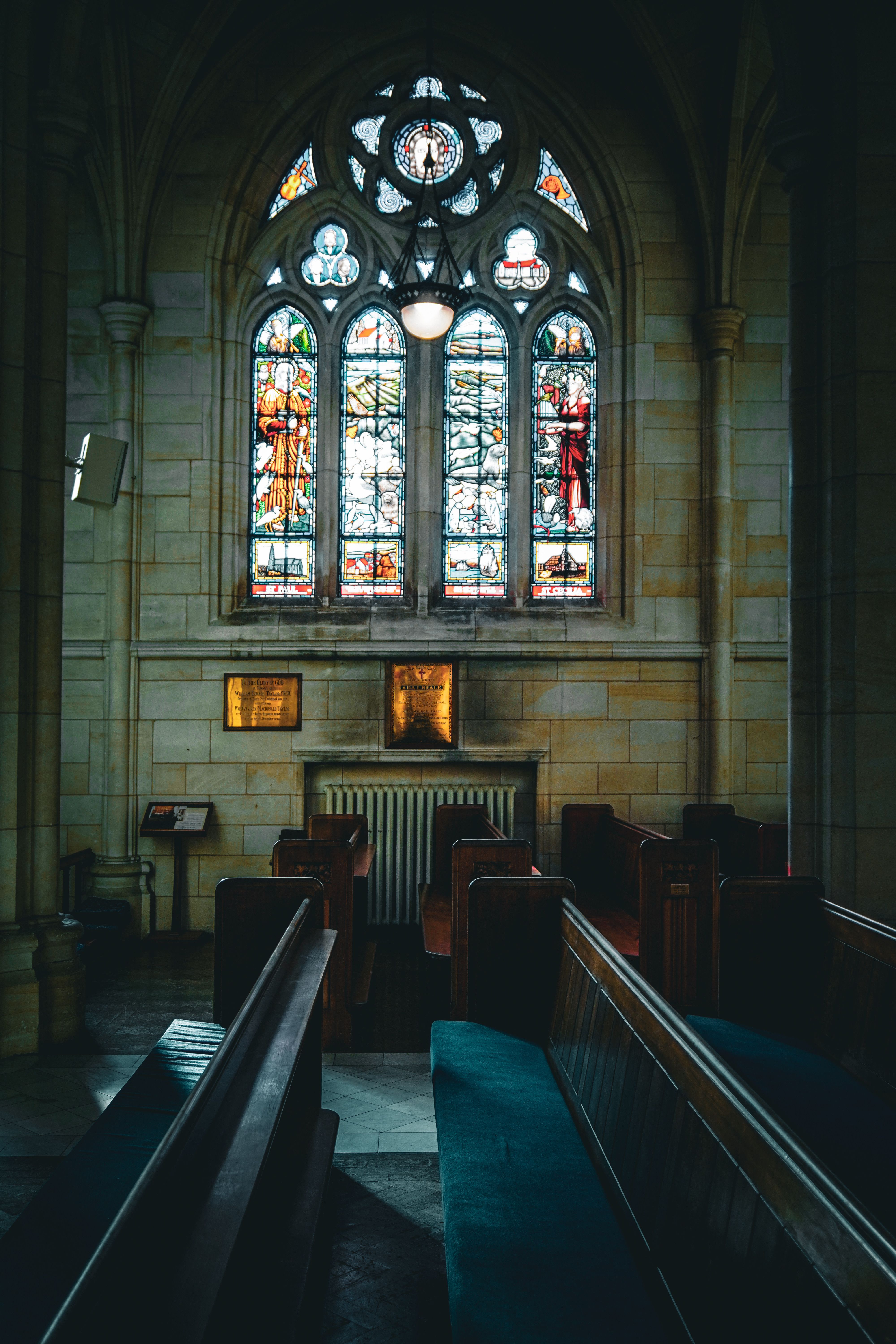 A serene church interior featuring stained glass windows and wooden pews, creating a peaceful ambiance.