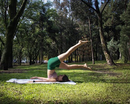 A woman performs a challenging yoga pose in a sunny park in Mexico City, promoting relaxation and fitness.