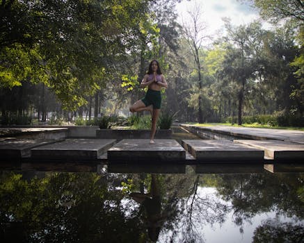 Woman practicing yoga by a reflective pond in a Mexico City park, showcasing tranquility and natural beauty.
