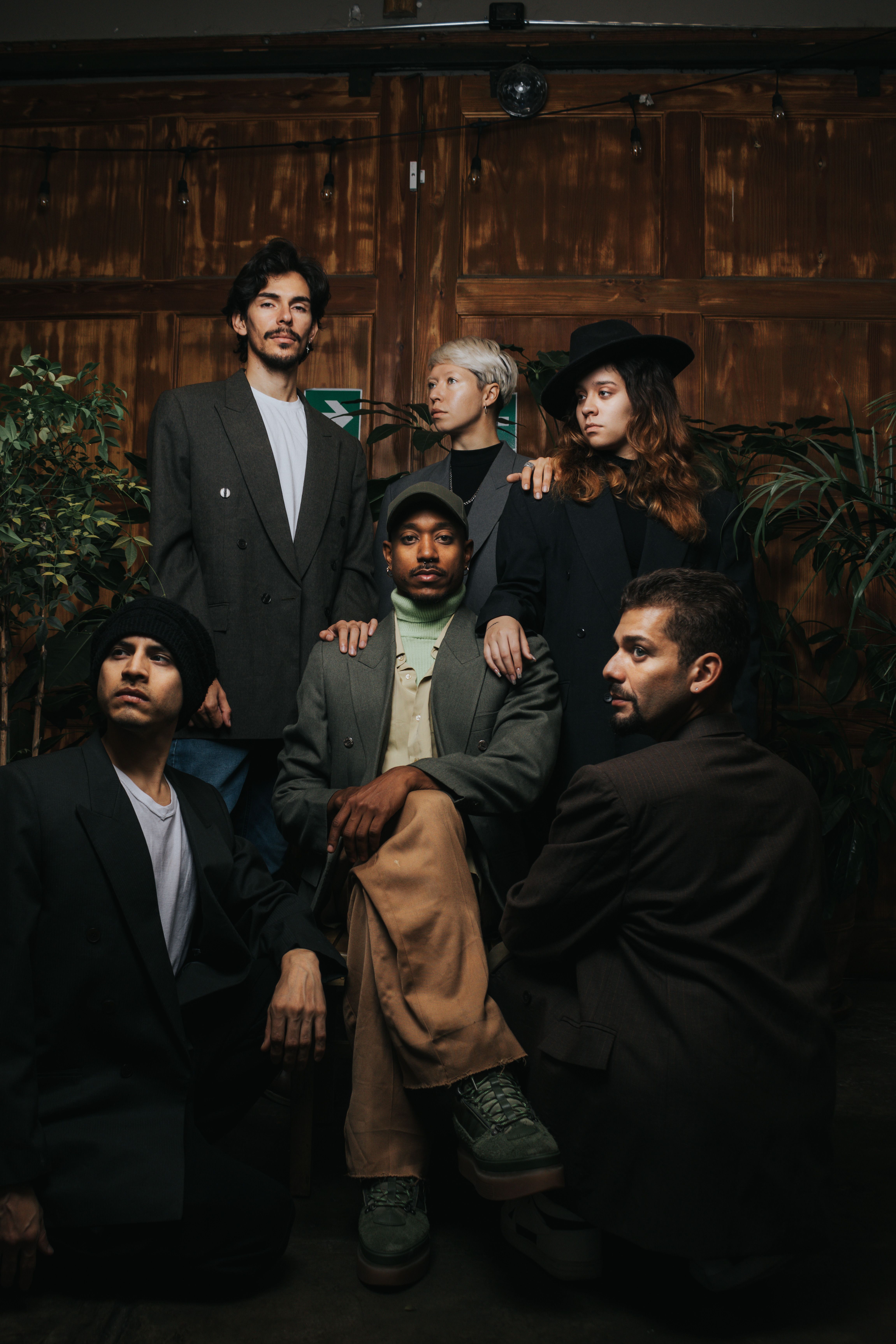 A conceptual group portrait featuring diverse individuals in stylish attire, captured indoors in Lima, Peru.