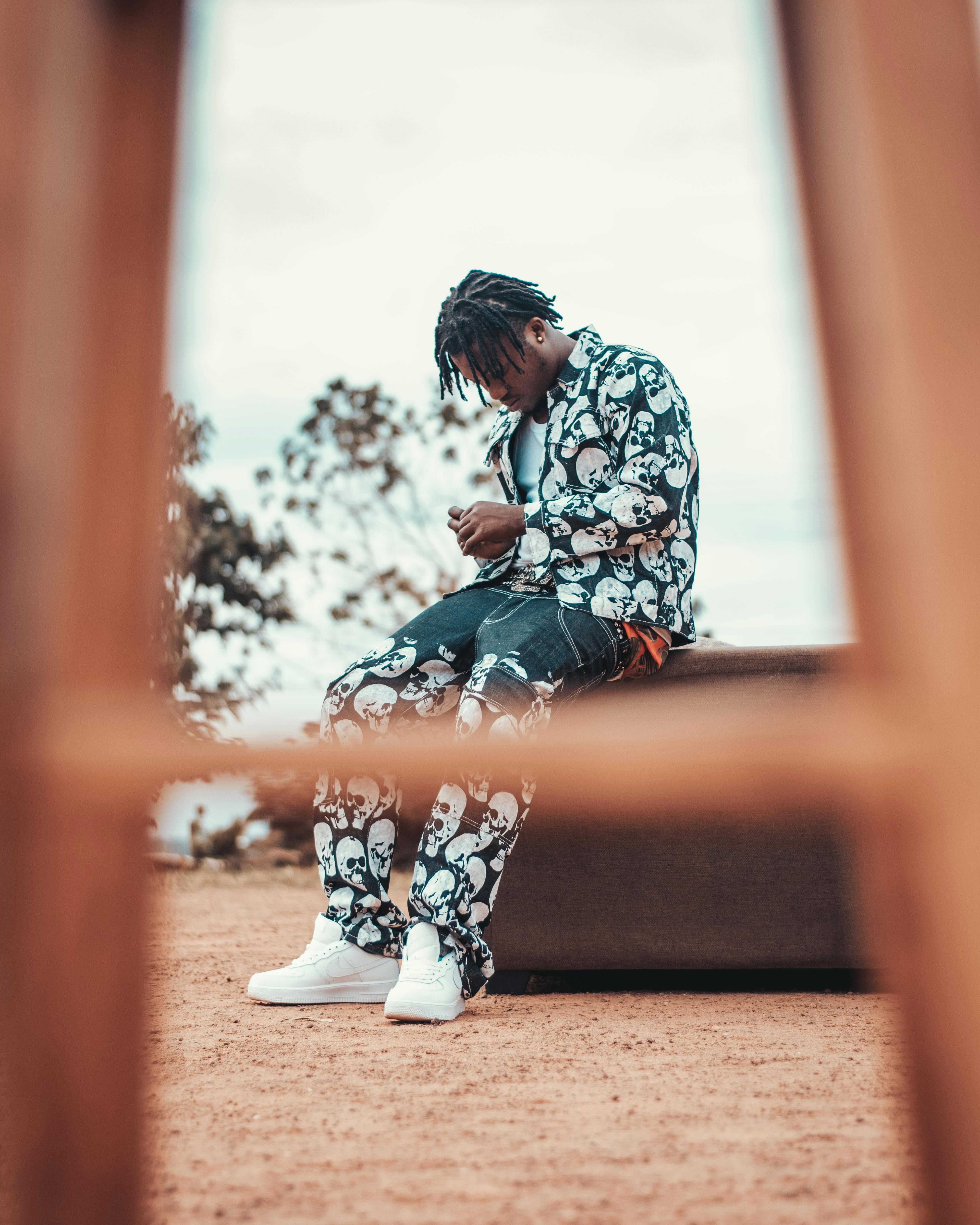 a man sitting on a bench with his phone