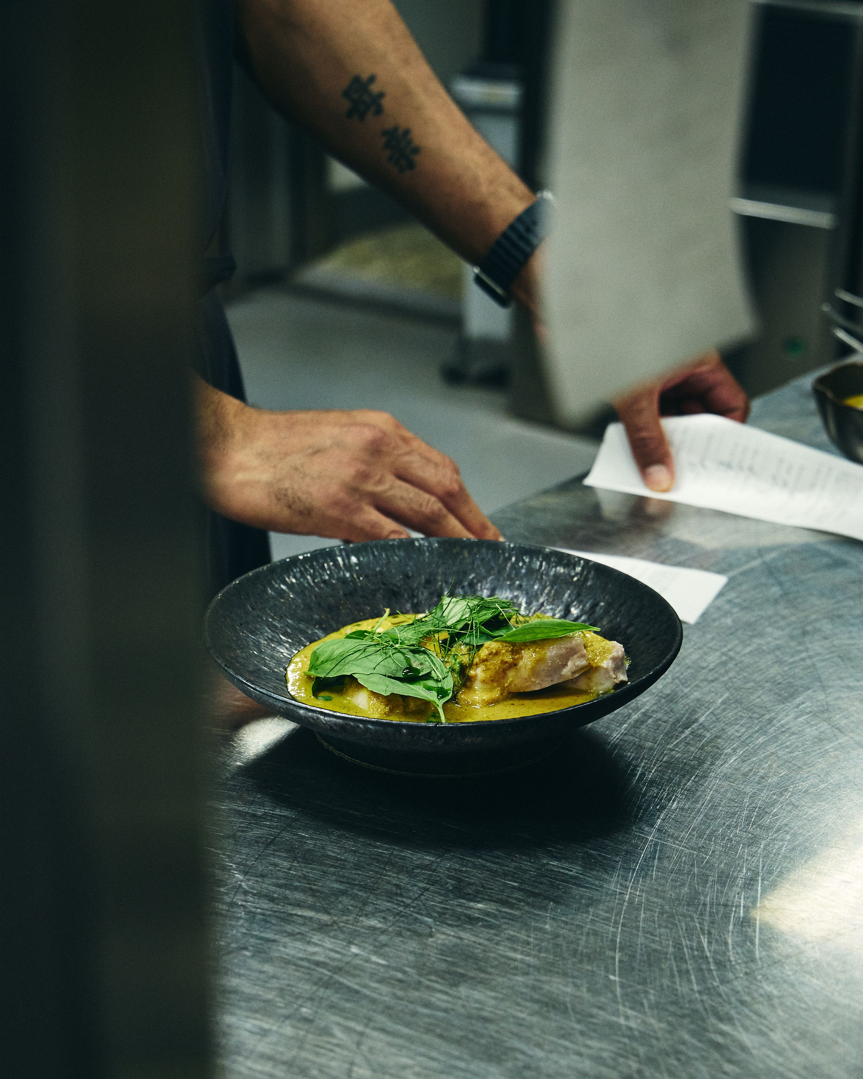 Hands plating a dish