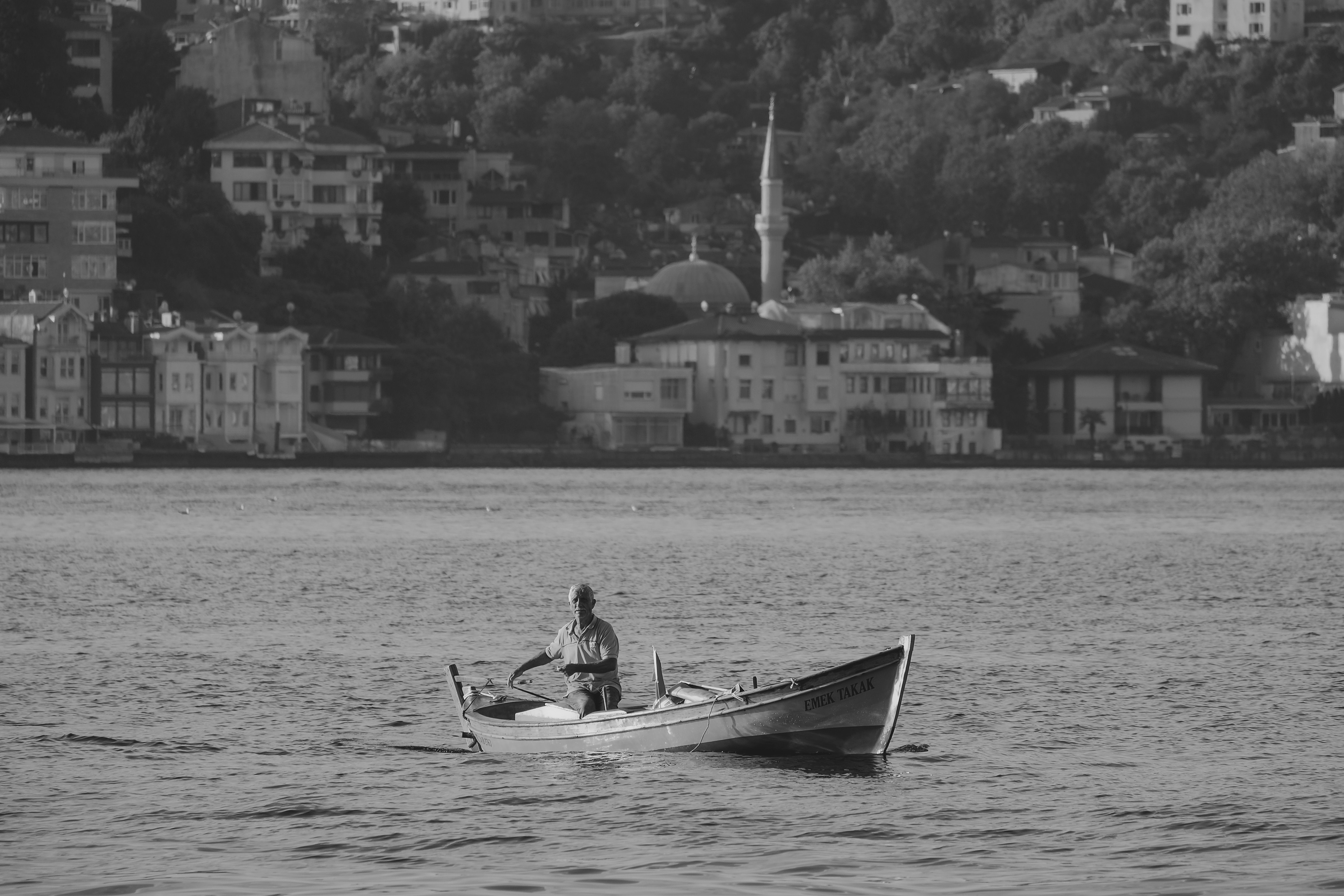 A man in a small boat on the water · Free Stock Photo