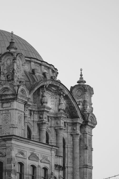 Free Stunning black and white capture of an ancient gothic building with a dome and intricate stone detailing. Stock Photo