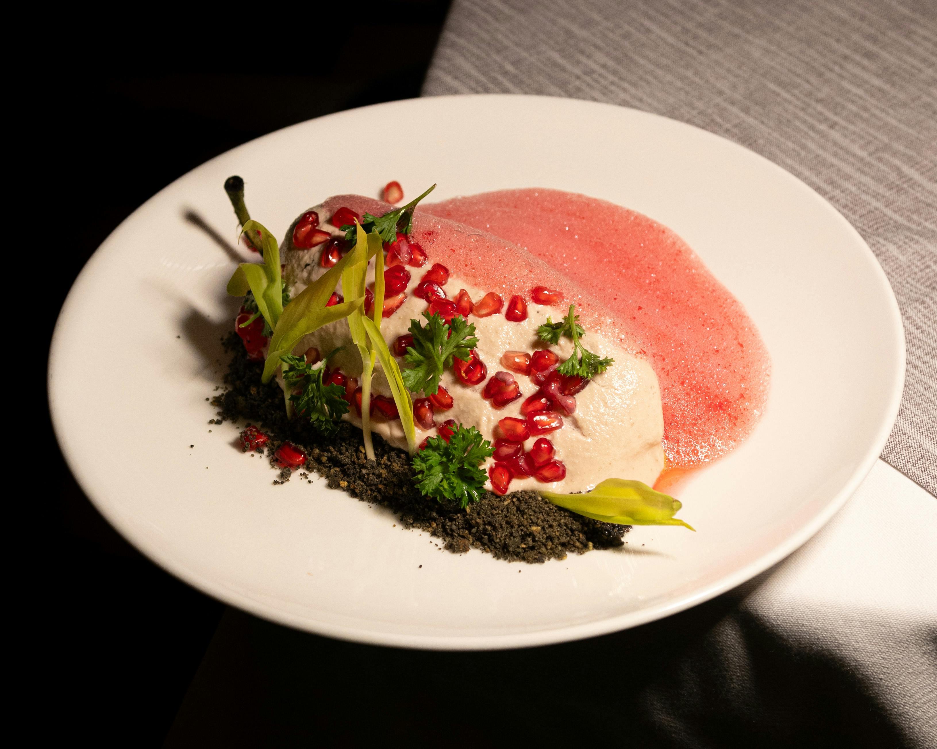 a plate topped with a piece of meat and garnish