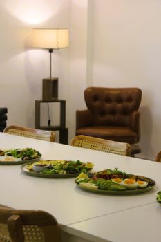 Indoor dining area featuring modern furniture and a stylish food presentation.