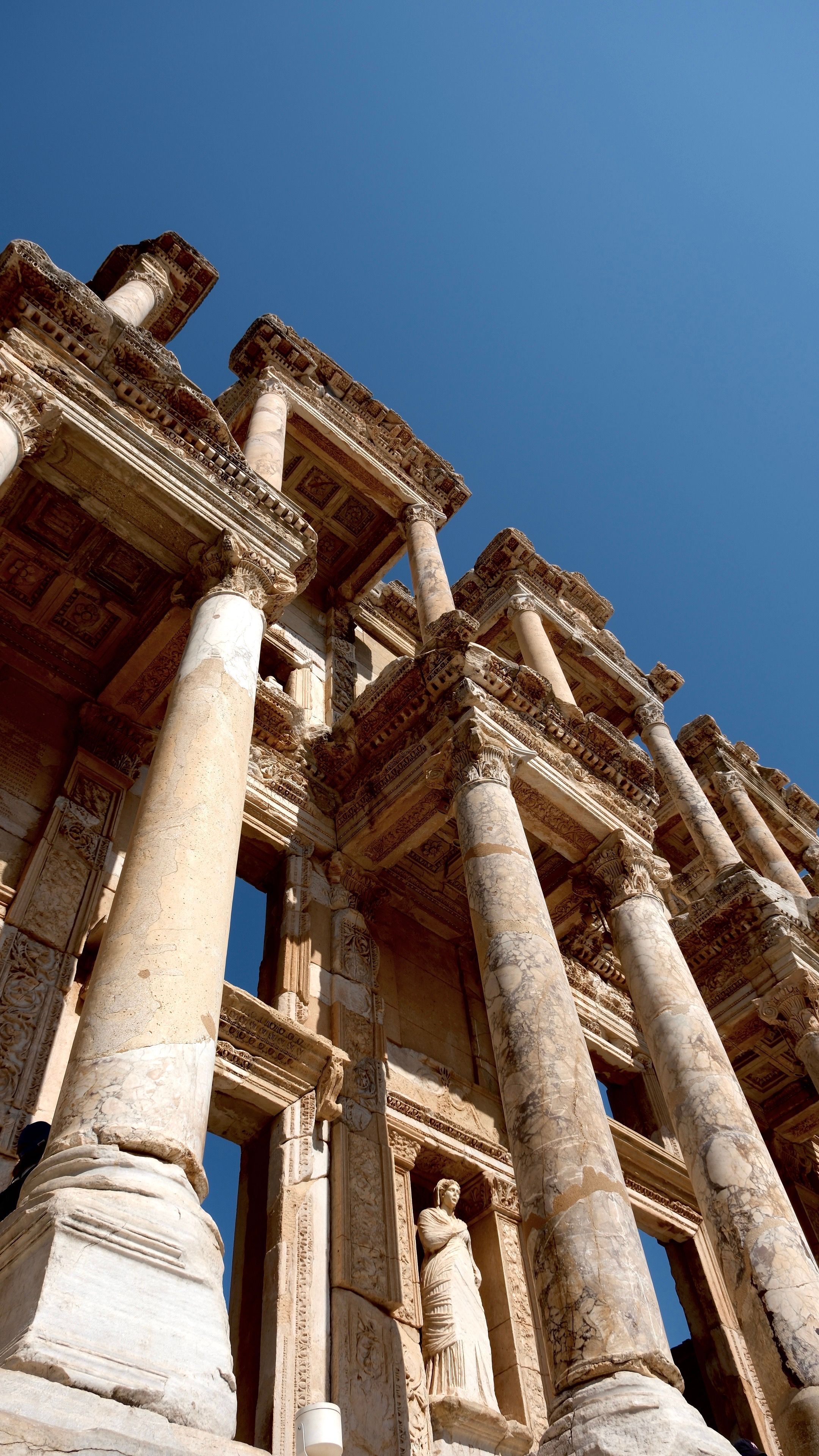 Stunning view of the ancient Celsus Library in Ephesus, featuring Roman architecture against a clear blue sky.