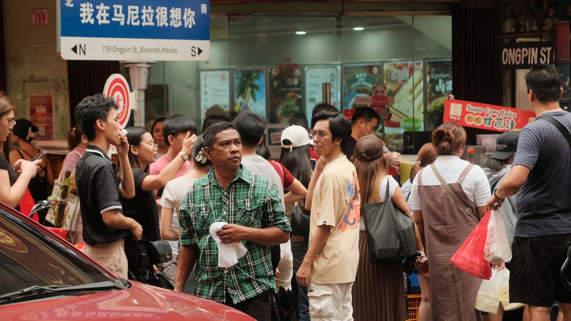A lively street scene in Binondo, Manila's Chinatown, showcasing daily life.