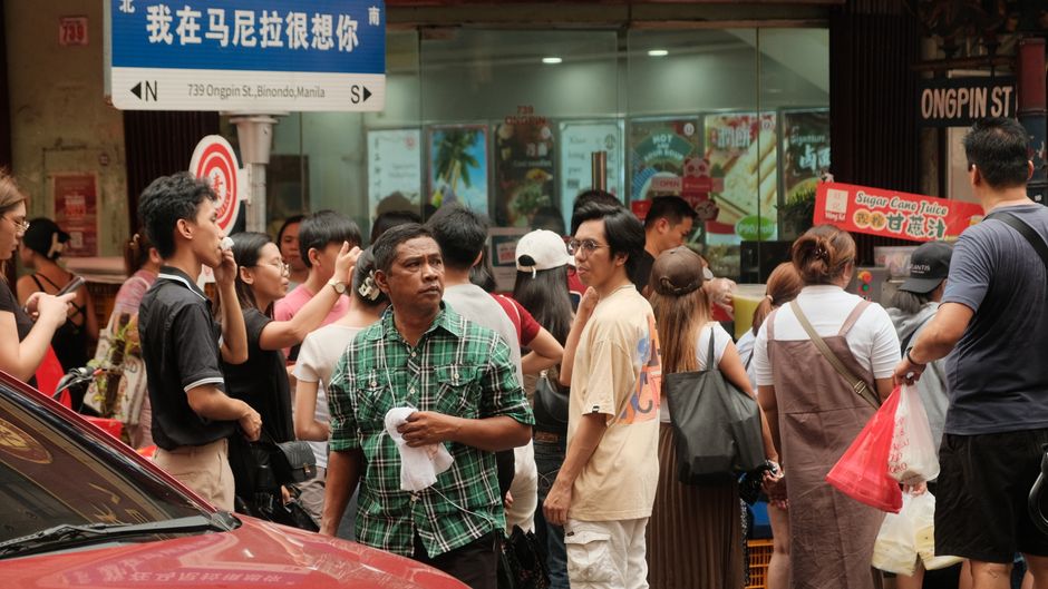 A bustling carinderia in the Philippines with various home-cooked Filipino dishes on display