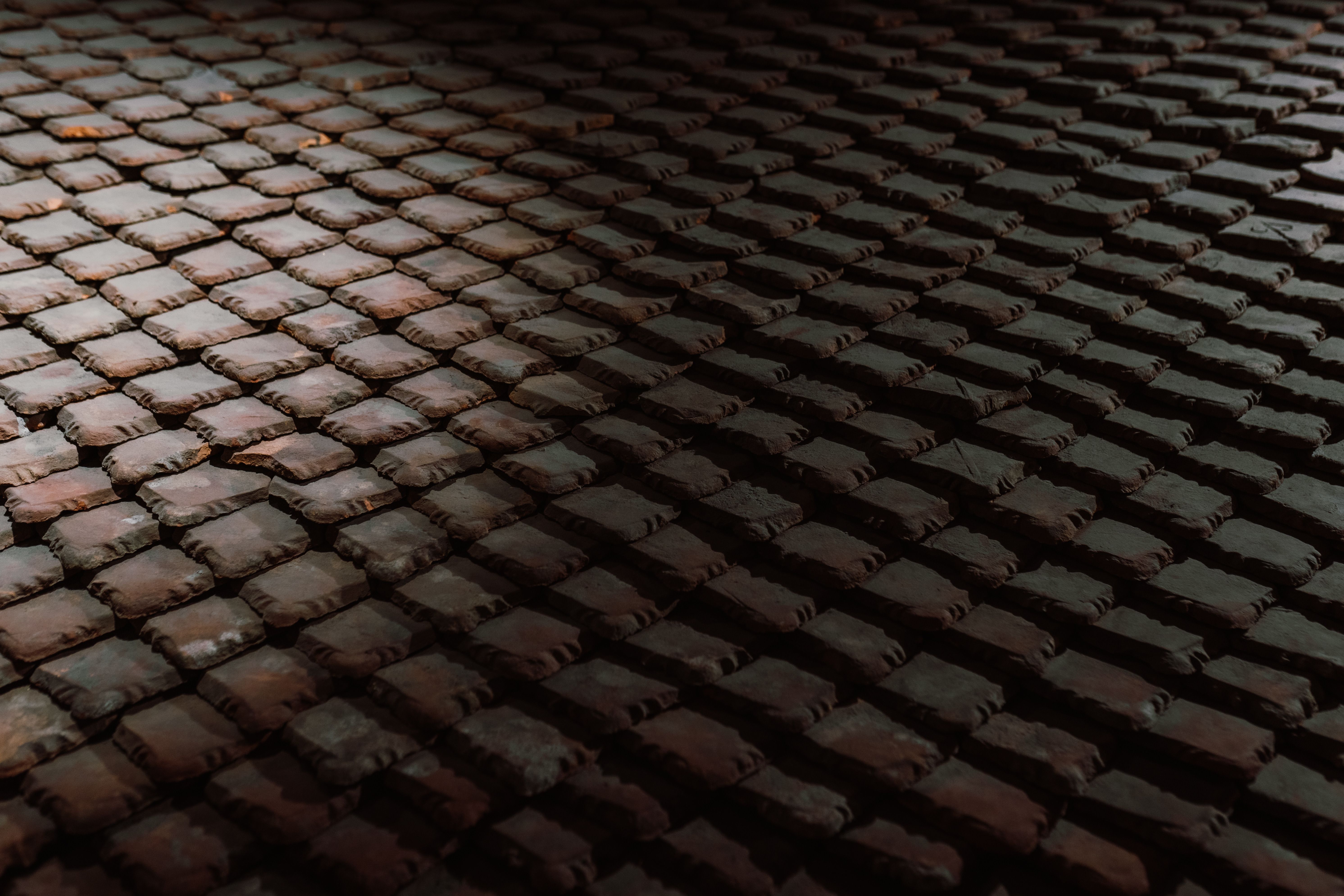 Rows of handmade cooling tiles in varied earth tones