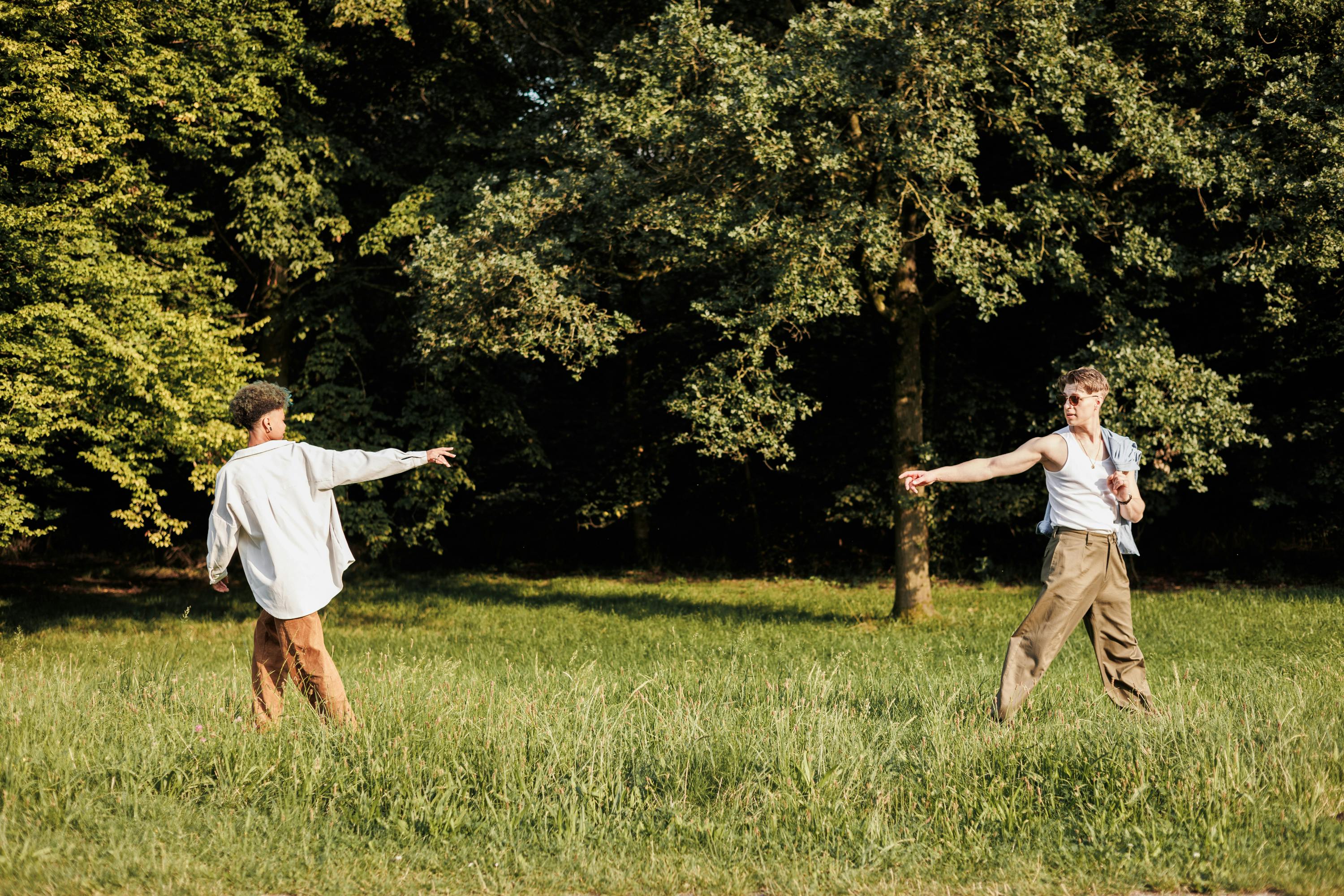 Two people are playing frisbee in a field