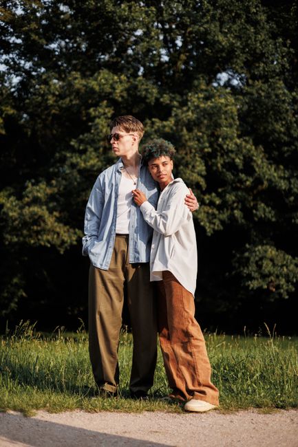 A loving couple embracing outdoors in a park, capturing a moment of togetherness and affection.