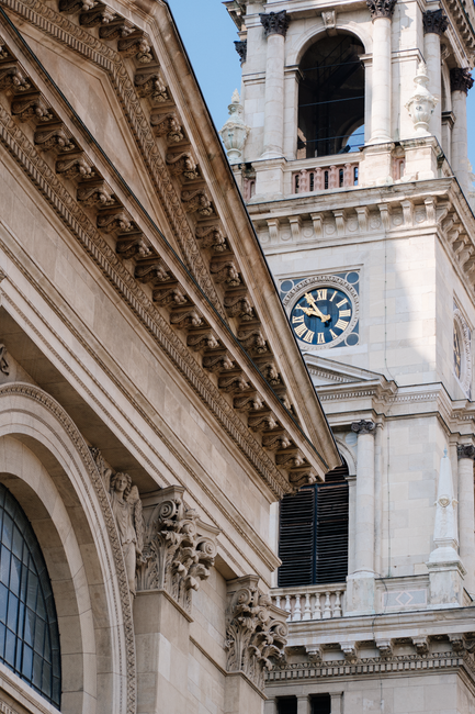 Intricate architectural details of St. Stephen's Basilica's facade and clock tower in Budapest, Hungary.
