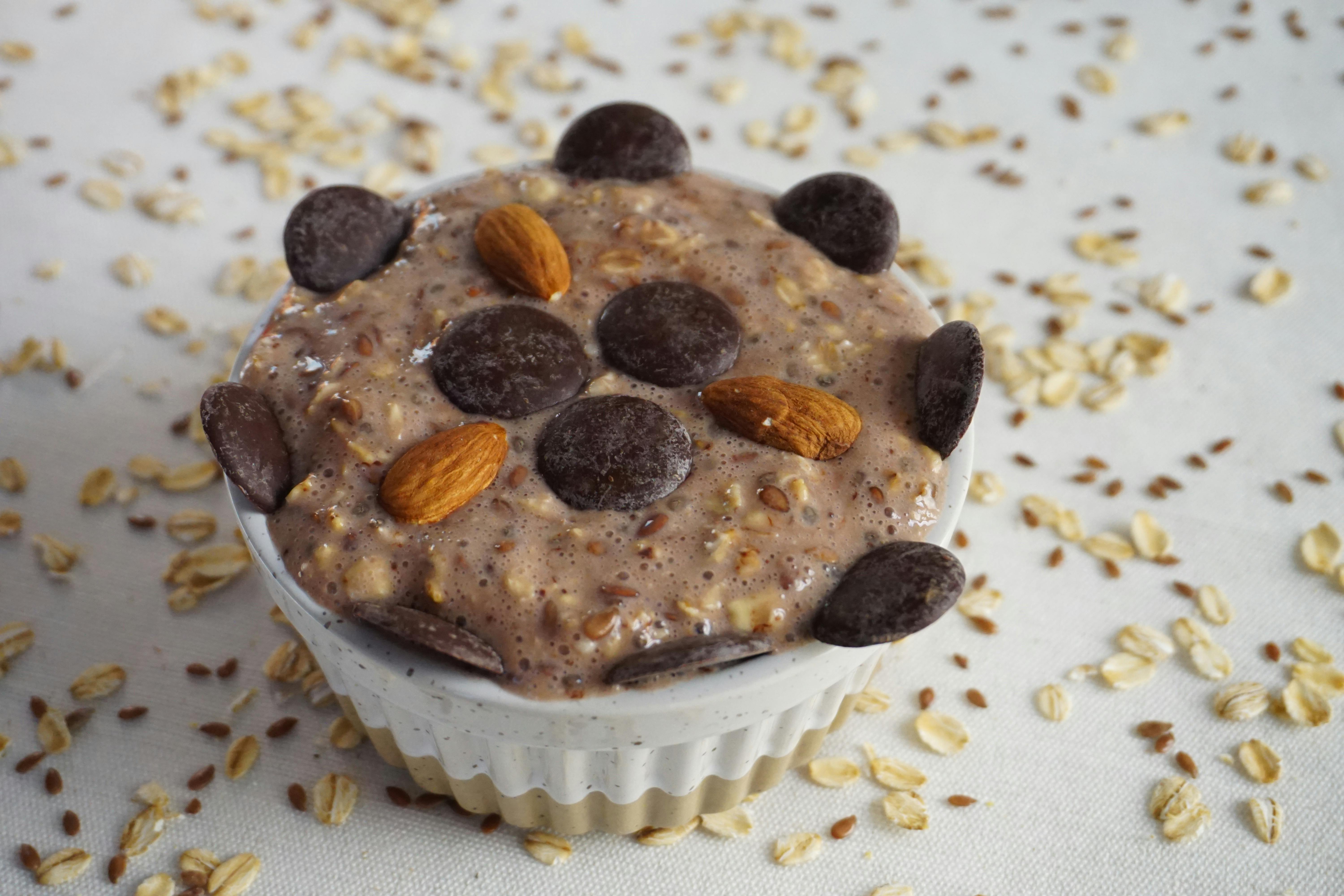 a cupcake with chocolate chips and nuts on top