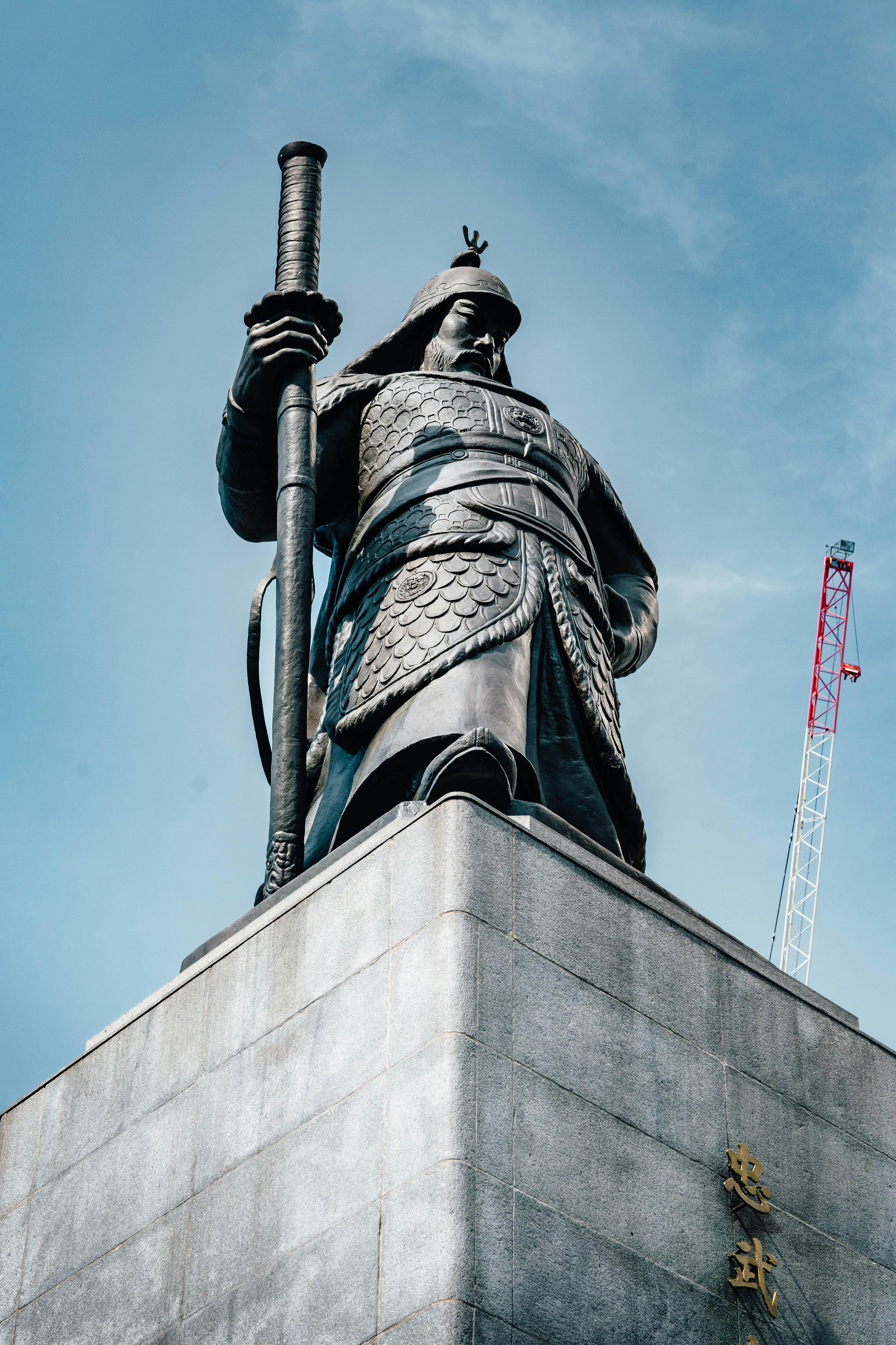 Admire the impressive statue of Admiral Yi Sun-Sin in Seoul, South Korea, against a clear blue sky.