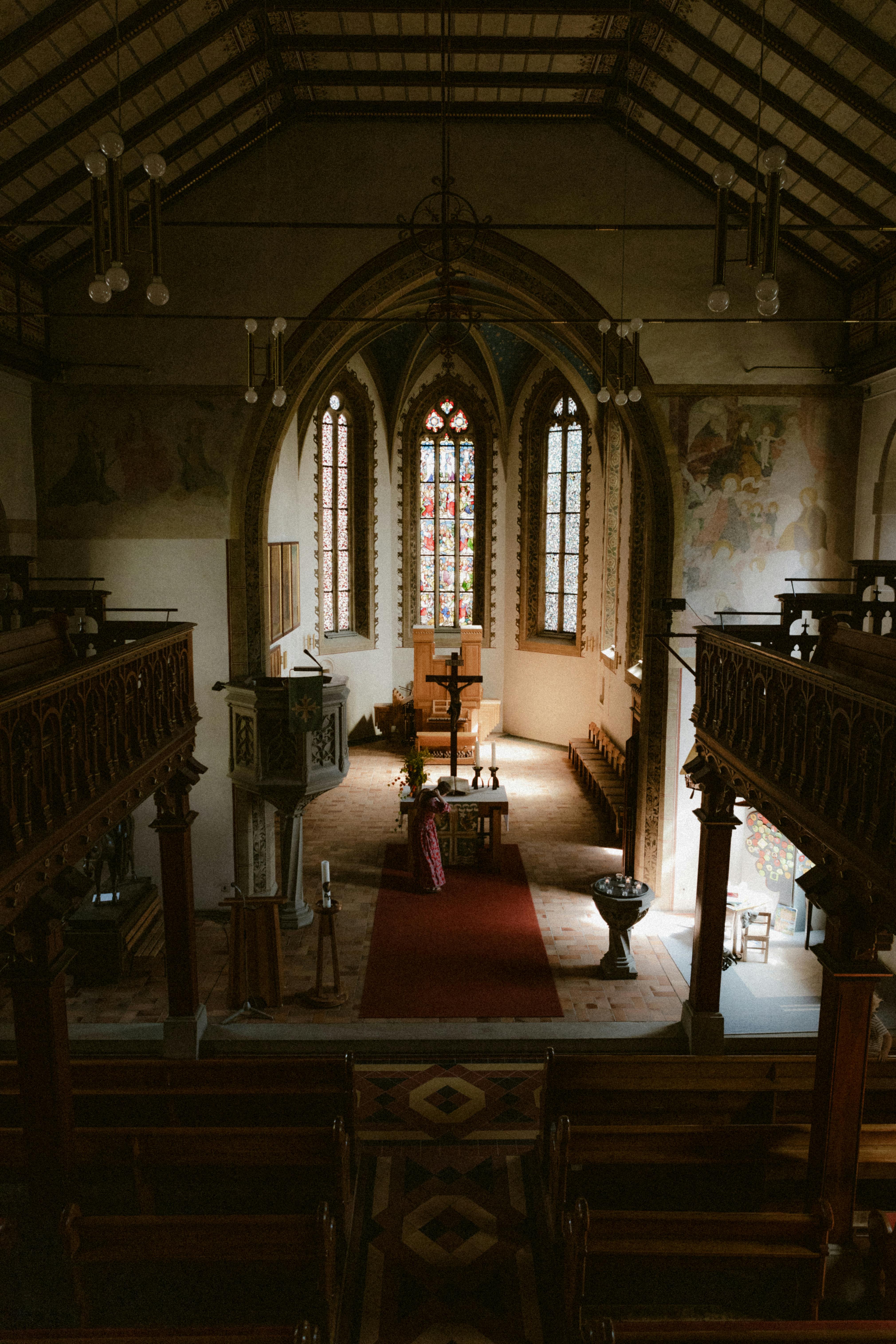 the inside of a church with a large wooden pew