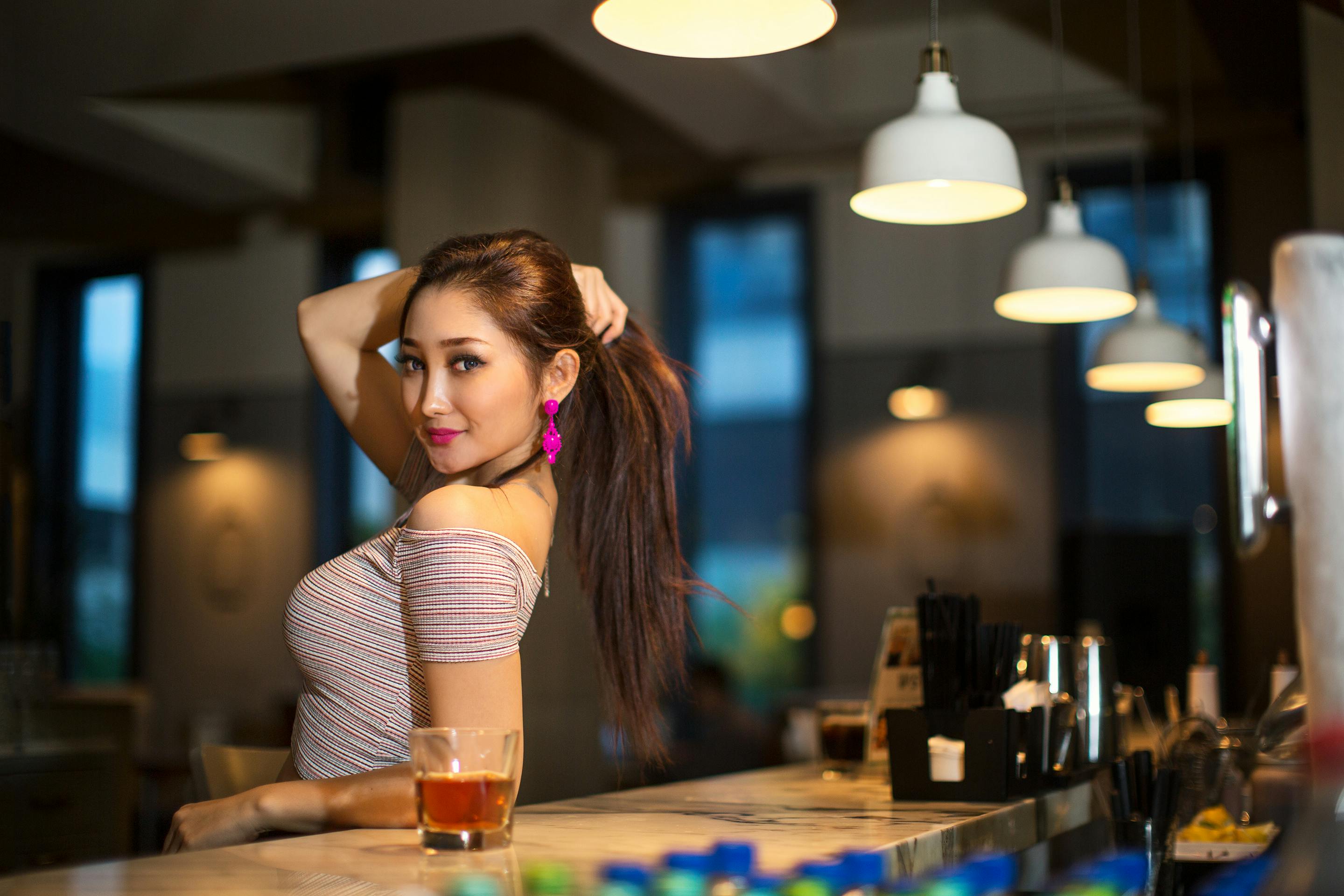 a woman is leaning against a bar counter