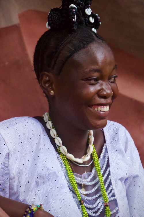 Free A joyful woman adorned in colorful beads and traditional attire, showcasing cultural fashion. Stock Photo