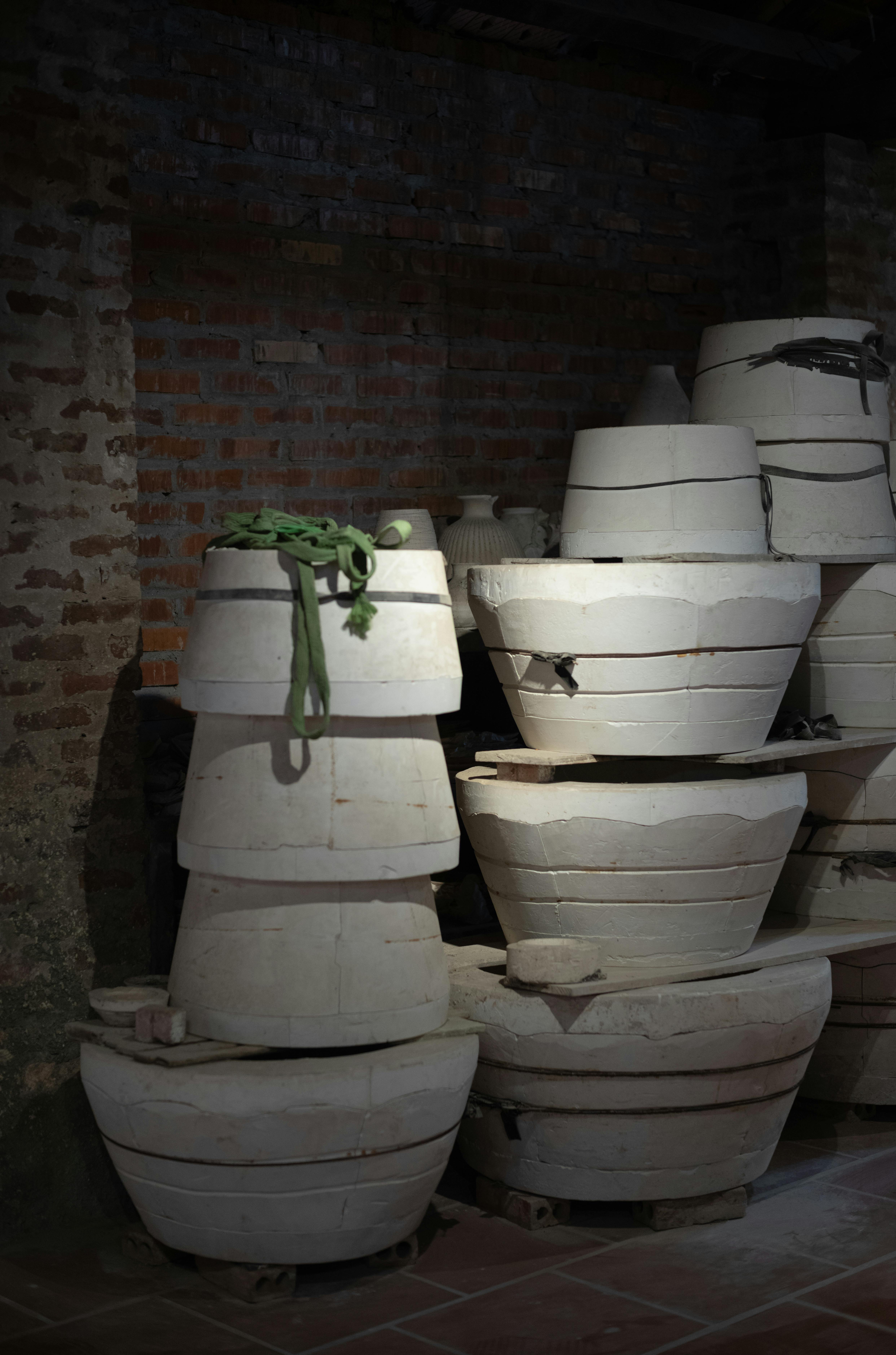 a pile of clay pots in a room