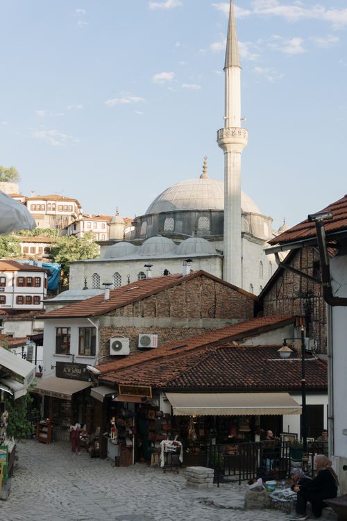 Free Explore a quaint street with traditional architecture and a historic mosque under a clear sky. Stock Photo