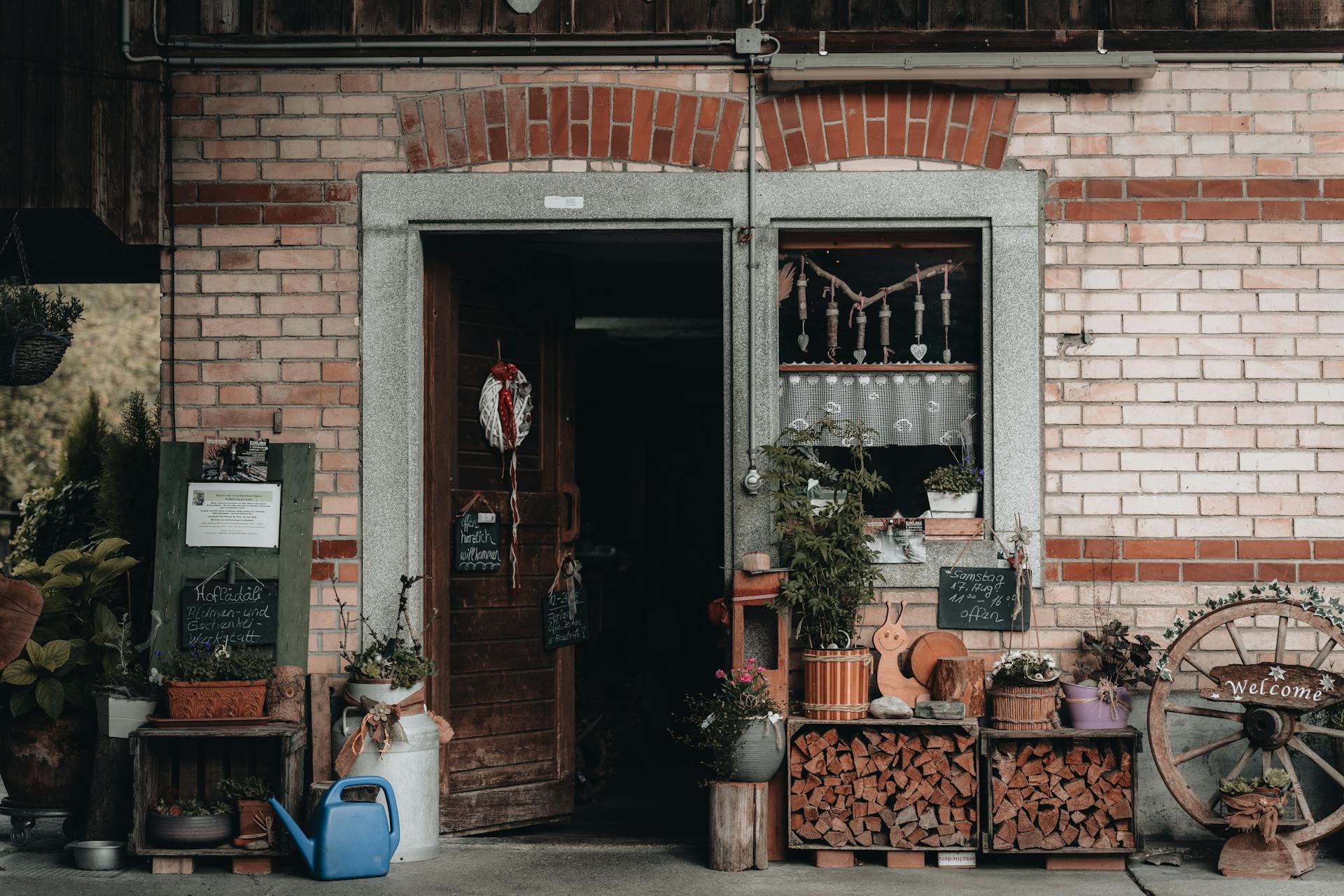 A charming rustic brick storefront adorned with plants and wooden decorations, inviting with a warm ambiance.