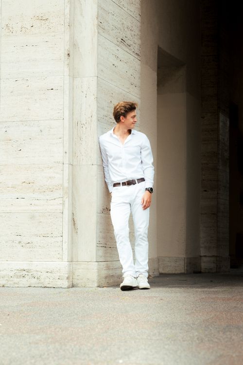 Free Young man in white outfit posing stylishly outdoors in Berlin urban setting. Stock Photo