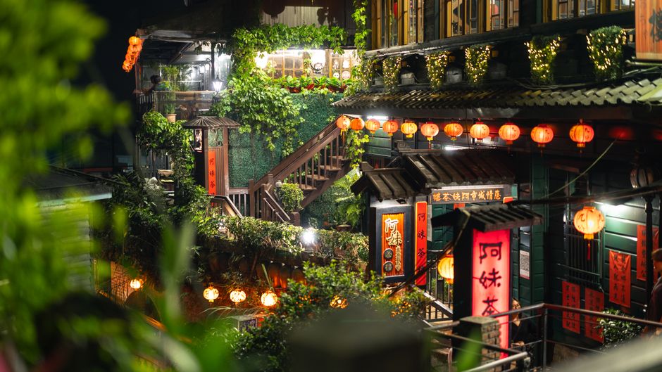 A beautifully illuminated street scene in Jiufen, Taiwan, showcasing traditional architecture and vibrant lanterns.