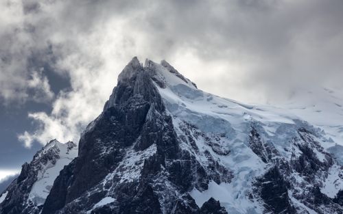 Free Stunning view of a snow-covered mountain peak in Patagonia under dramatic clouds. Stock Photo