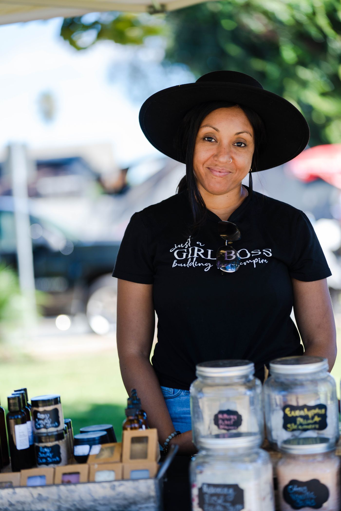 Small business owner displaying handmade products at a market