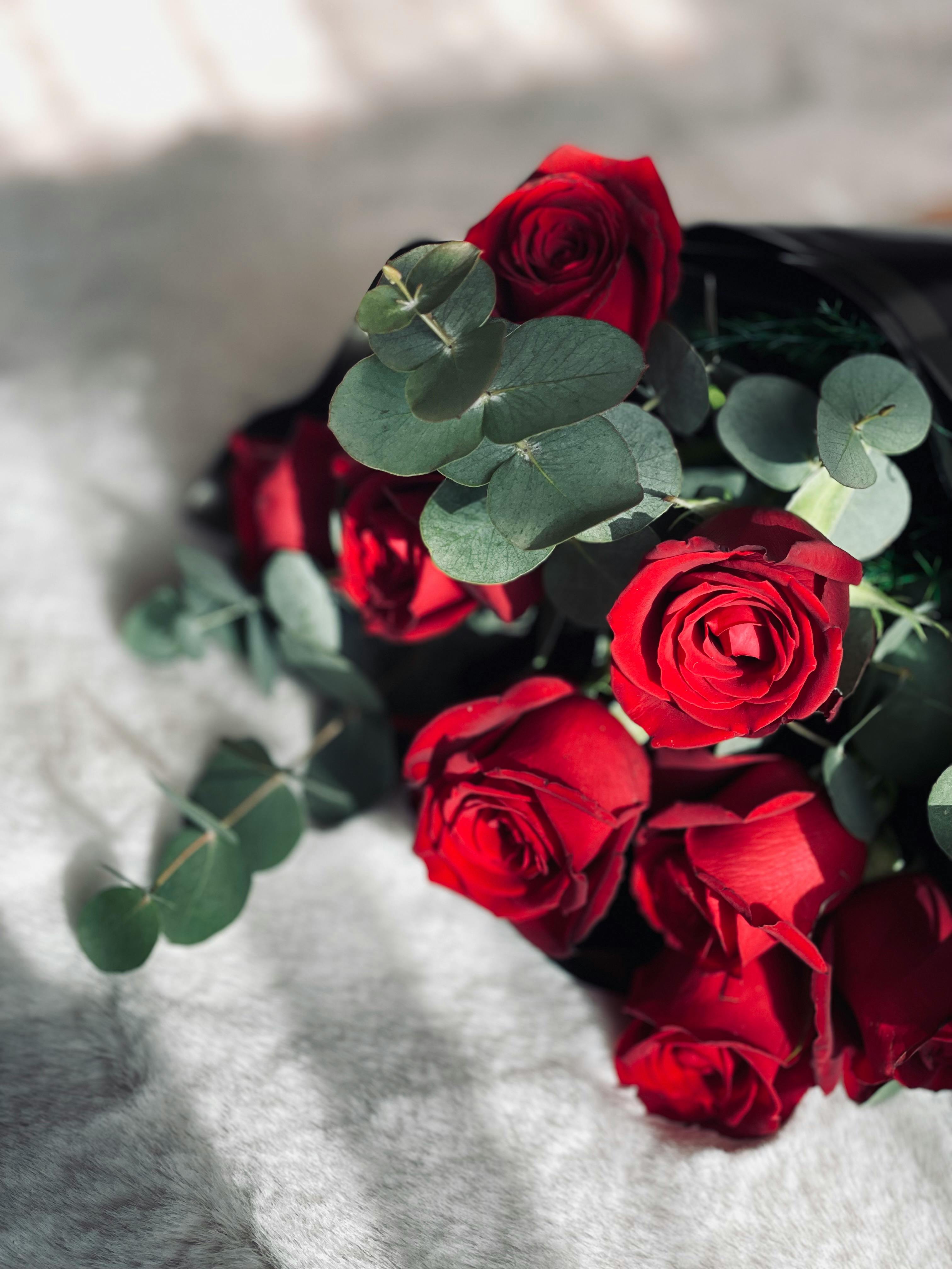 A stunning bouquet of red roses with eucalyptus, perfect for romantic occasions.