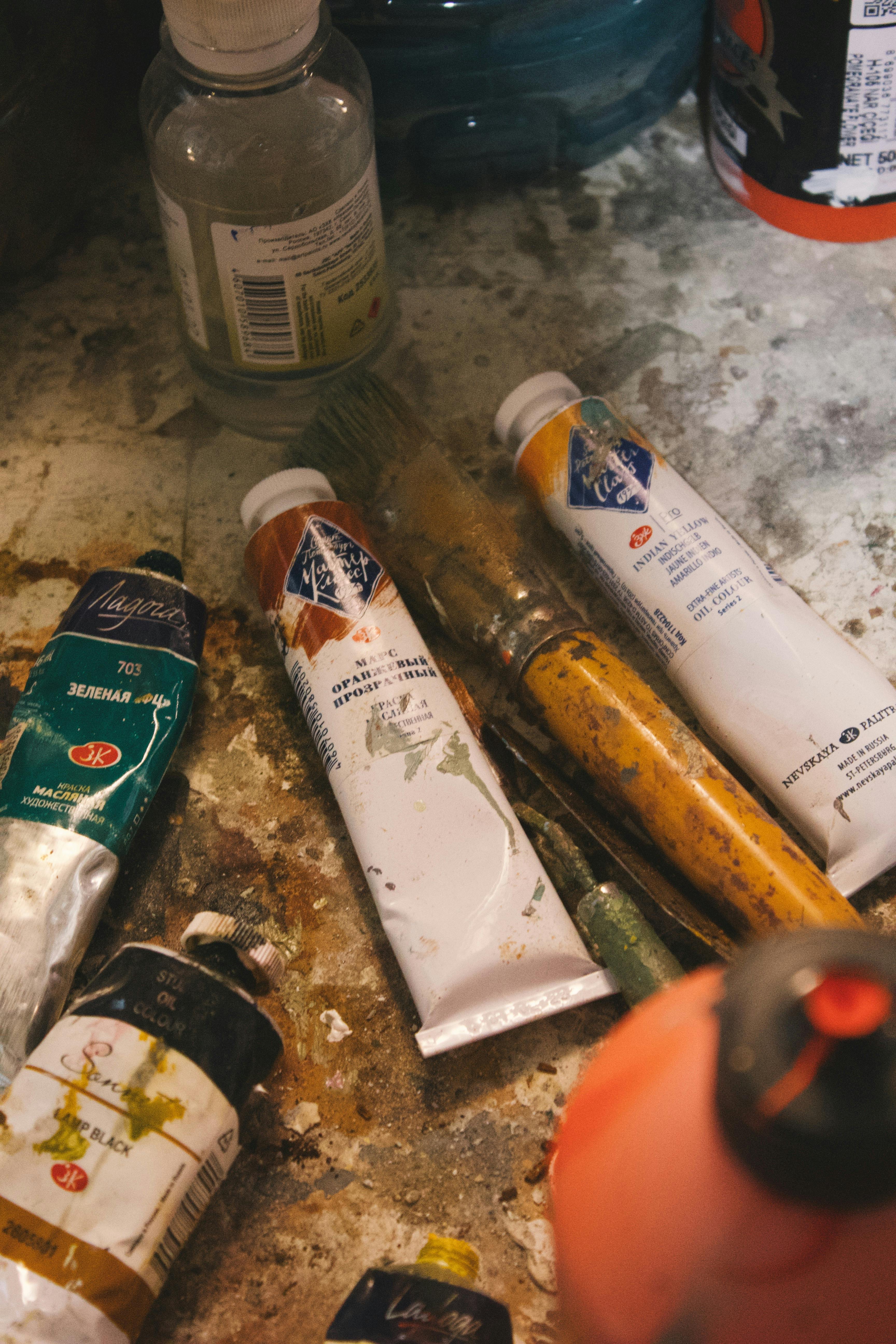 a pile of paint and other items on a table