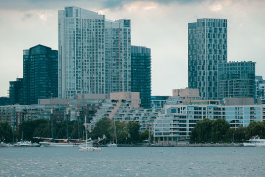 A dynamic view of Toronto's skyline featuring modern buildings and a harborfront scene.