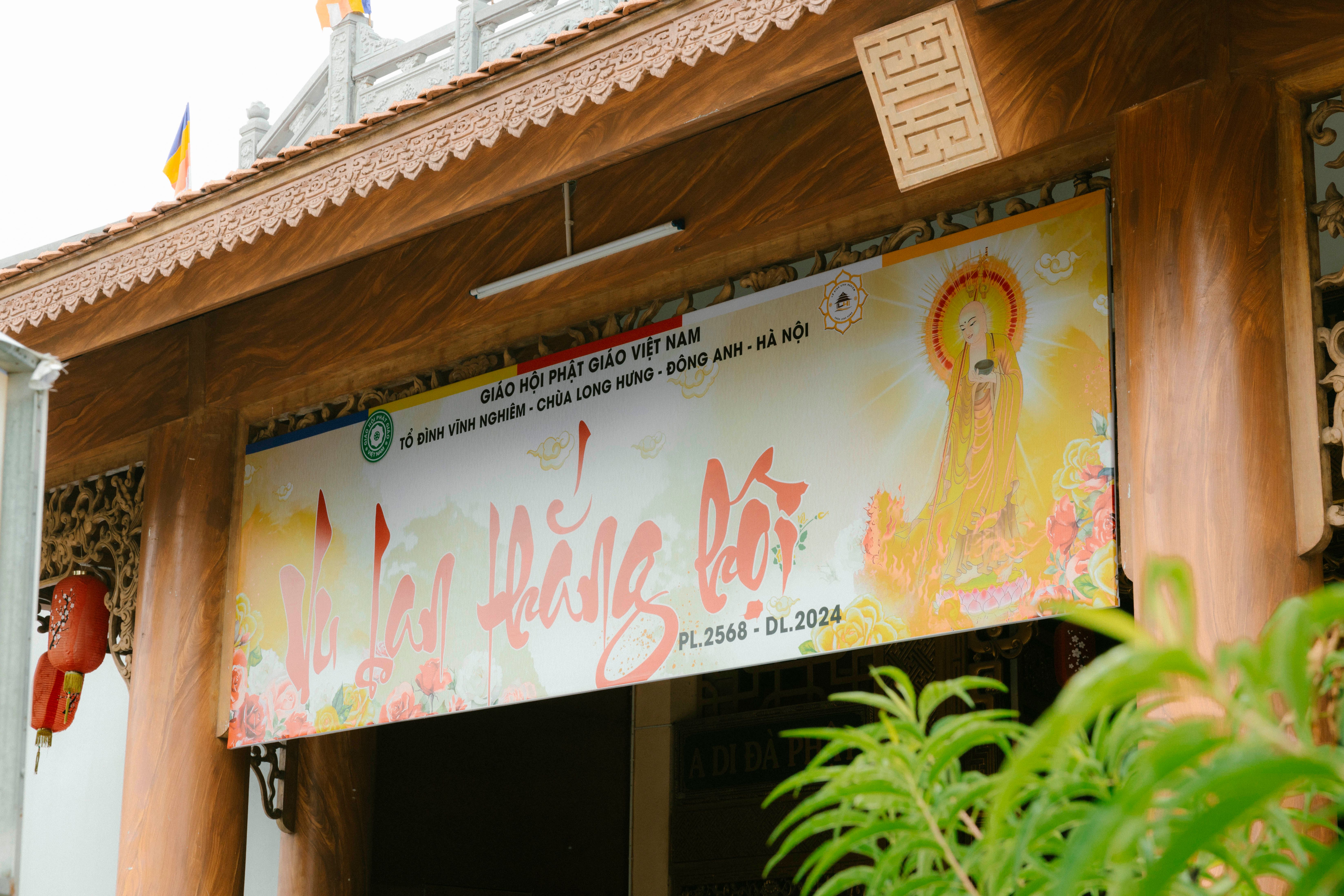 A traditional Vietnamese temple entrance with colorful cultural signage.