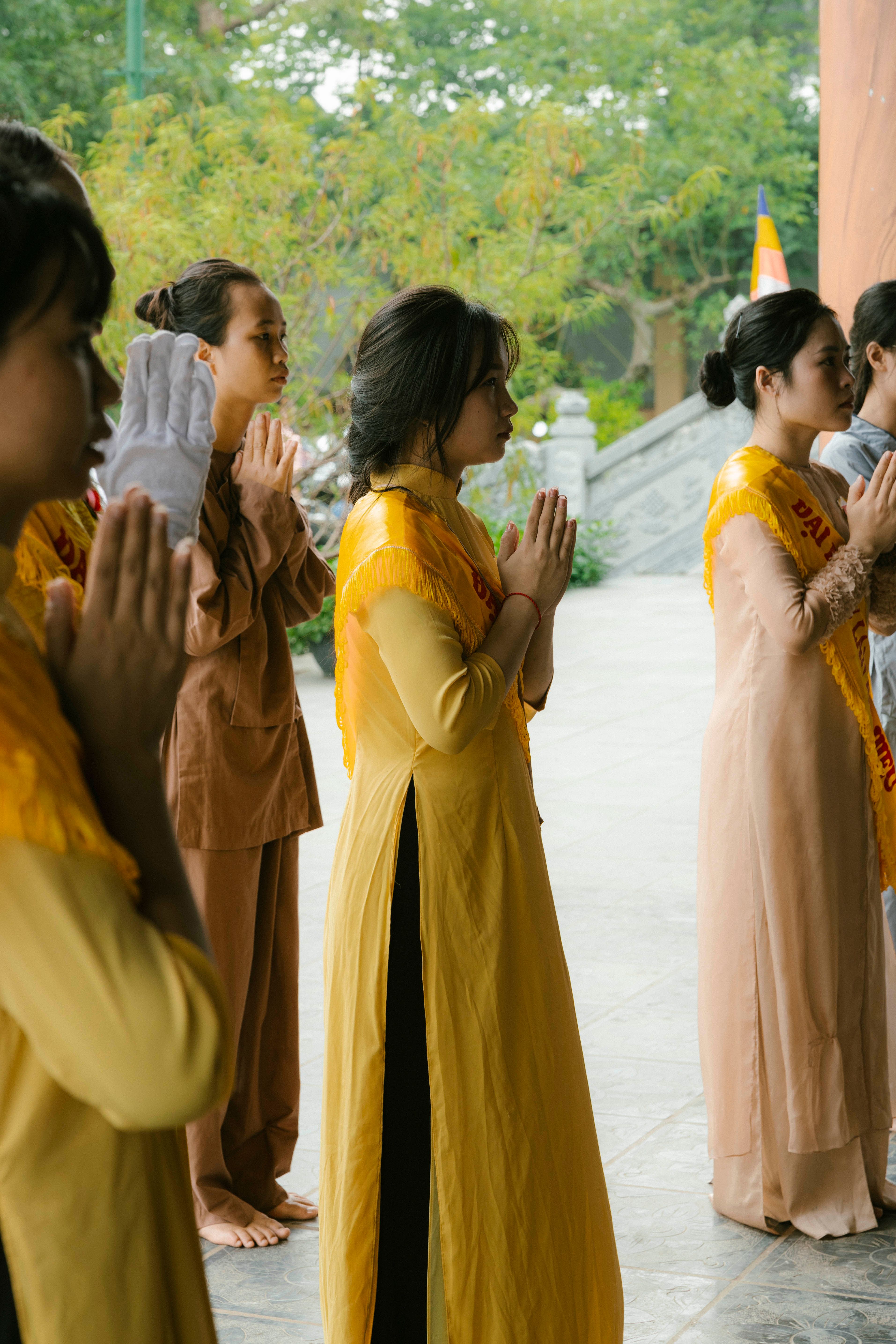 A diverse group of young adults meditating in a park, not a traditional religious setting